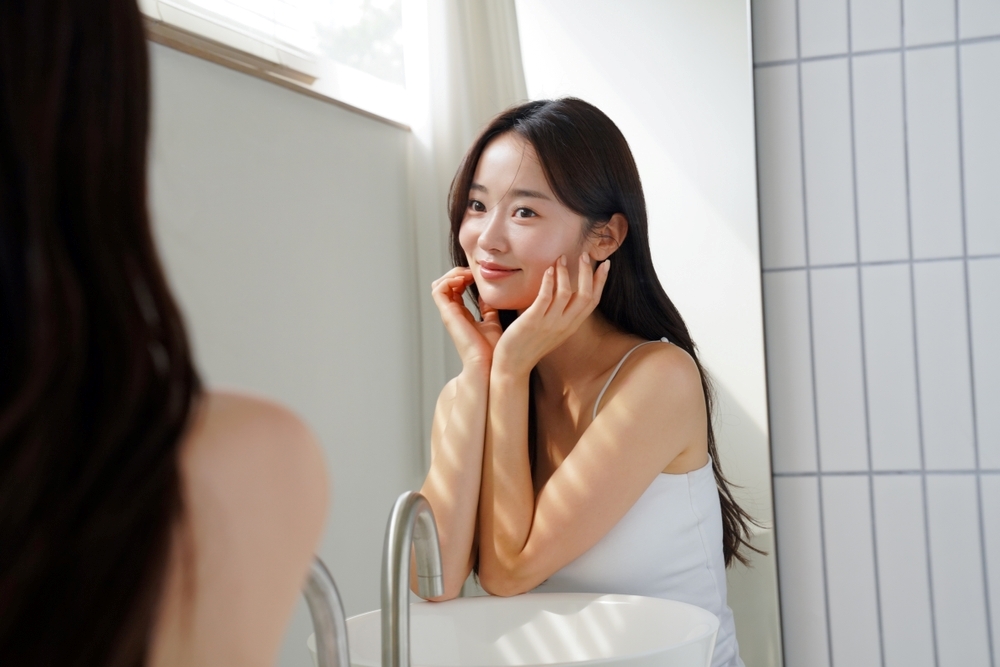 Woman checking facial skin condition before professional microneedling treatment in a cosmetic clinic