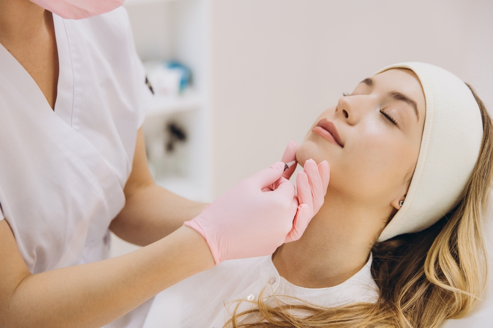 Cosmetic specialist performing Jawline Filler consultation and facial assessment in aesthetic clinic