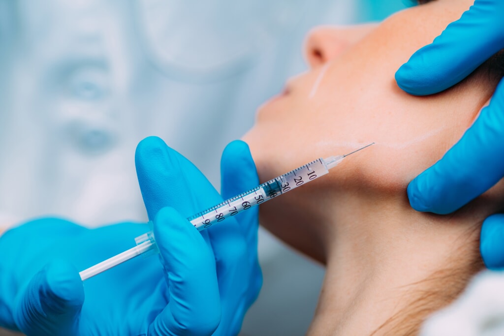 Woman receiving a facial injection