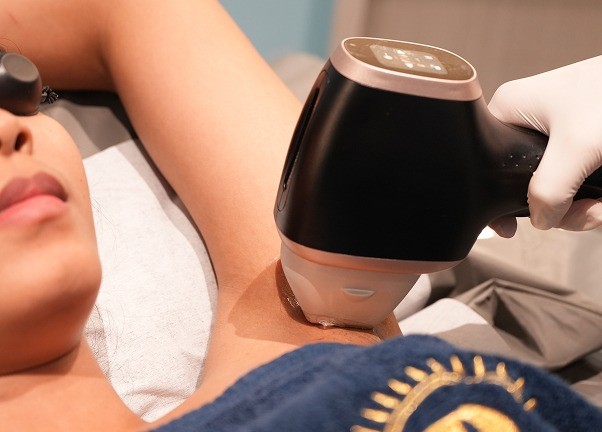 Woman receiving underarm hair removal